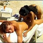 Horny lesbians suntanning nude on the beach